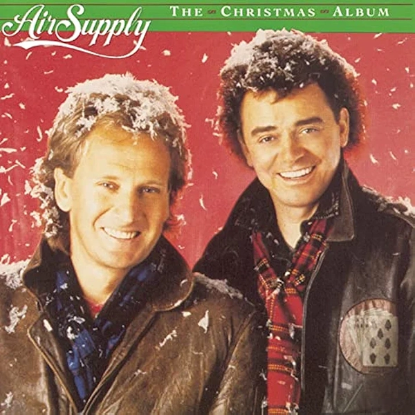 Album Cover "Air Suppy: The Christmas Album." Graham Russell and Russell Hitchcock wear leather jackets with Chrismas scarfs while snow falls around them.
