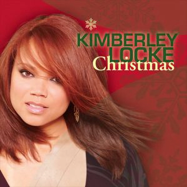 Album Cover "Kimberley Locke Christmas." Kimberley Lock looks into the camera. Christmas snowflake images embellish the background.