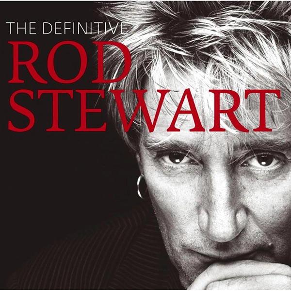 Album Cover "The Definitive Rod Stewart." Rod Stewart, in a closeup, rests his chin on his hand and looks intently into the camera.